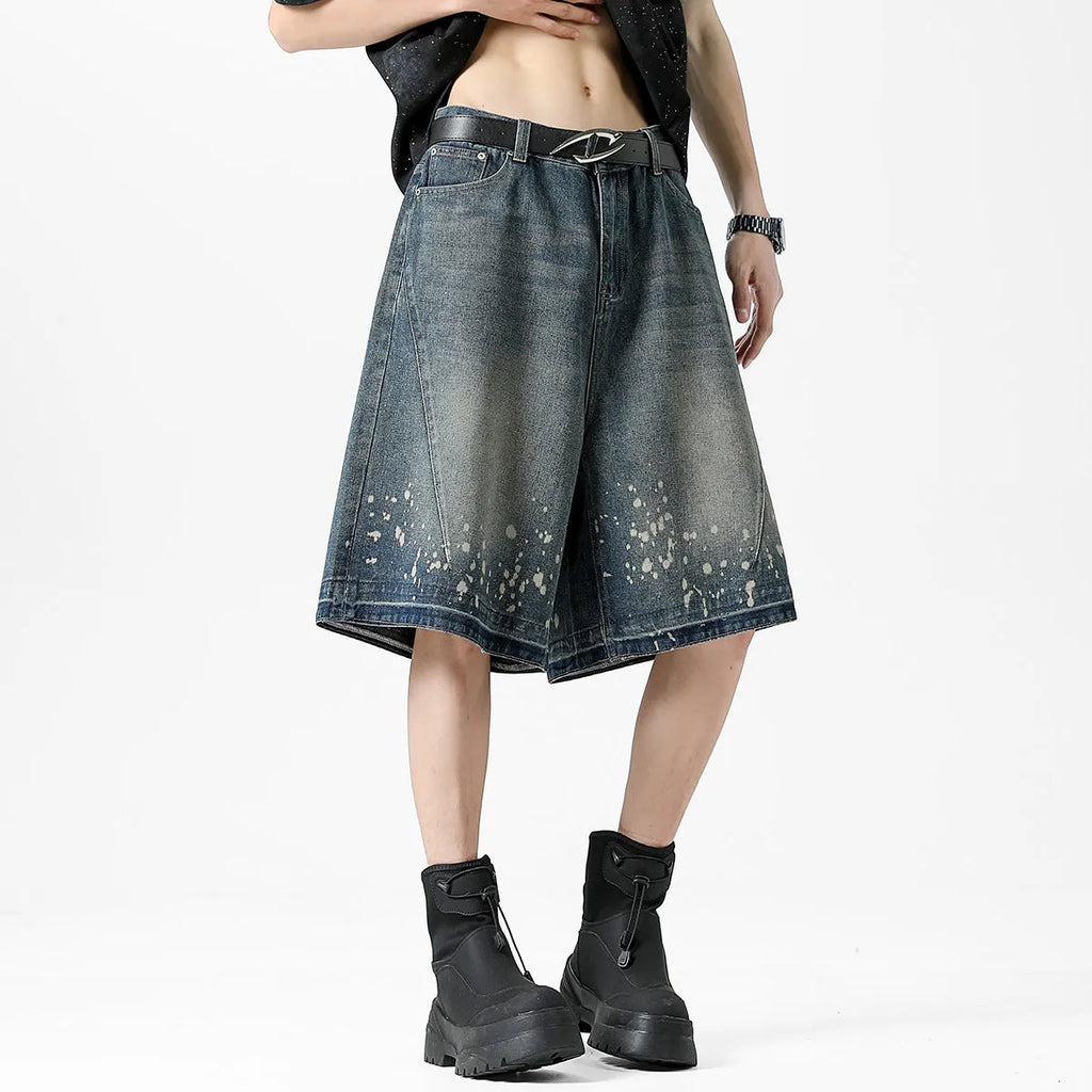 Men's straight cut denim shorts with retro blue wash and ripped splash ink details