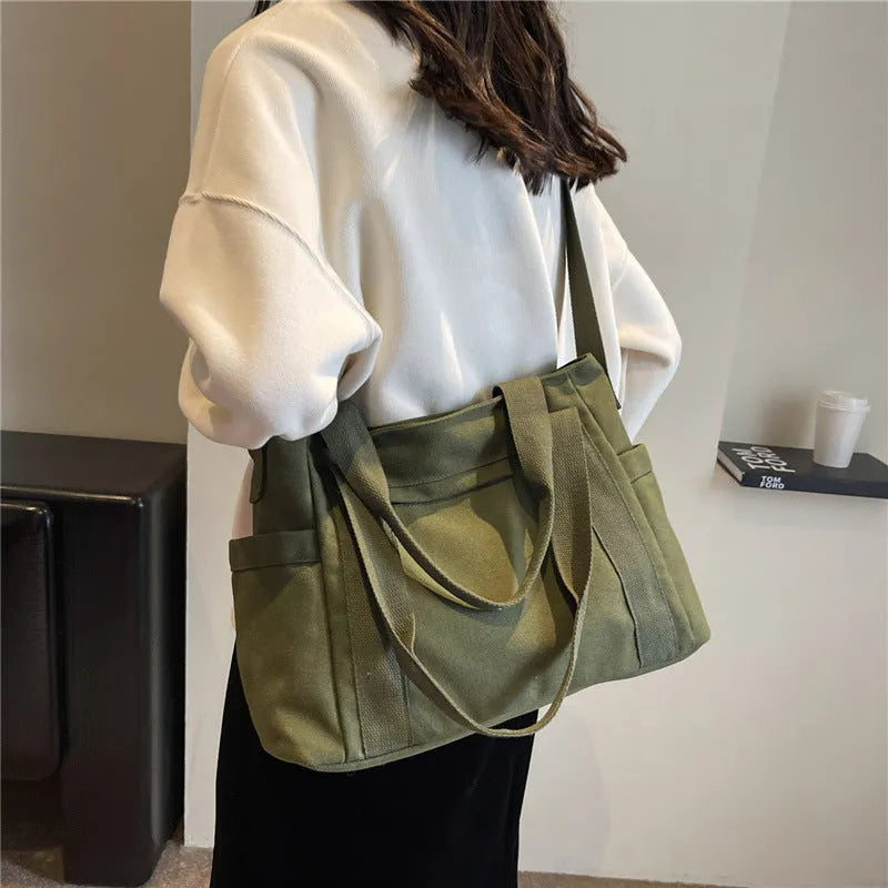 Large canvas shoulder bag for women in solid colour with external pocket and internal phone compartment