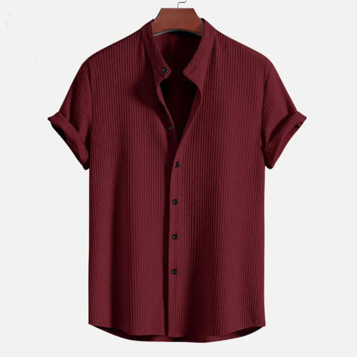 Men's loose short sleeve summer shirt in multiple colours on a hanger.