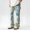 Yellow and blue retro jeans with patchwork and splash-ink damaged design, mid-waist cut.