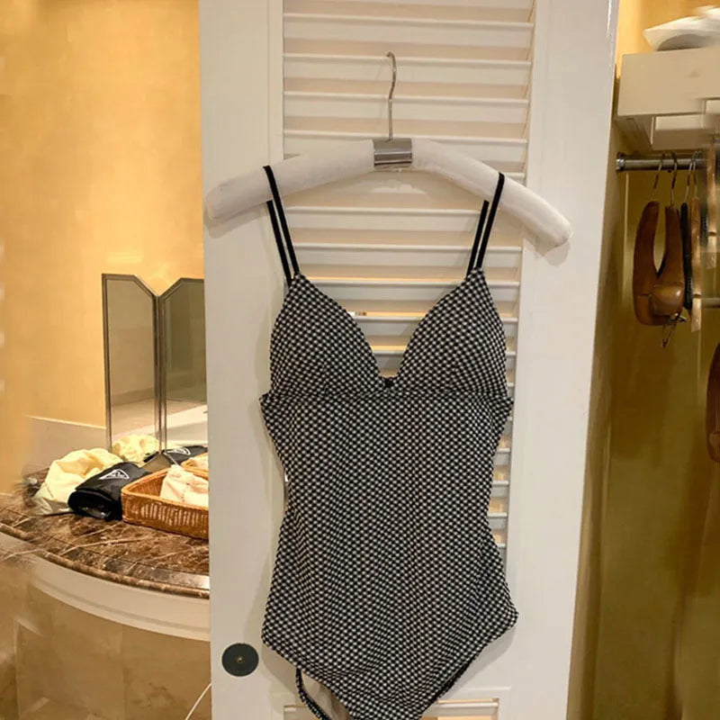 Blue one-piece swimsuit with cover belly design for women on a mannequin.