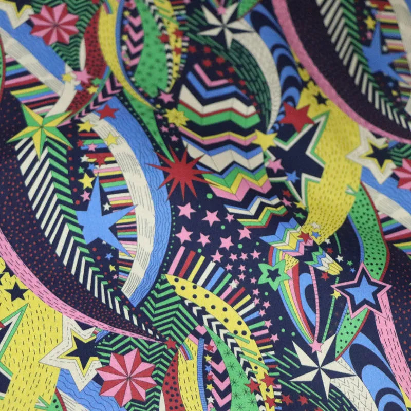 Blue cotton fabric with digital print of plants and flowers, showing 145cm width.