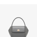 A wing-shaped women's leather tote bag with a buckle latch, shown in blue with a cross-body strap.