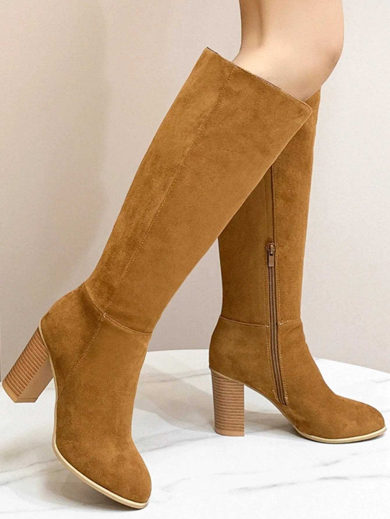 Women's black square toe high heel fashion boots made from artificial PU leather.