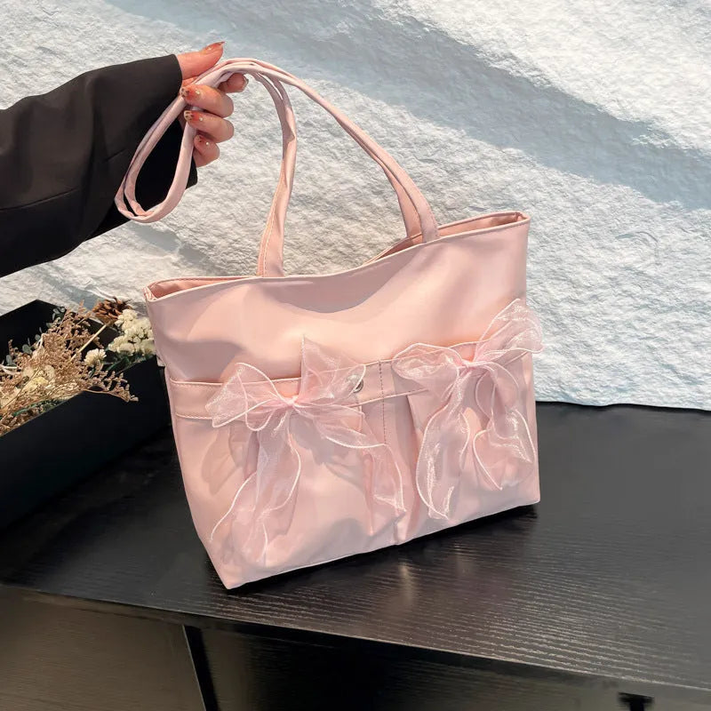 College style bow tote bag in black or pink with double shoulder straps and zippered compartment