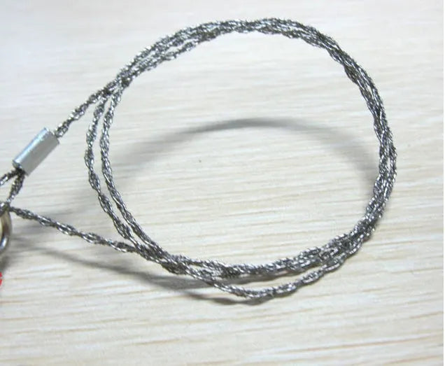 Stainless steel survival wire saw with thumb rings showing 55cm blade and pull ring assembly