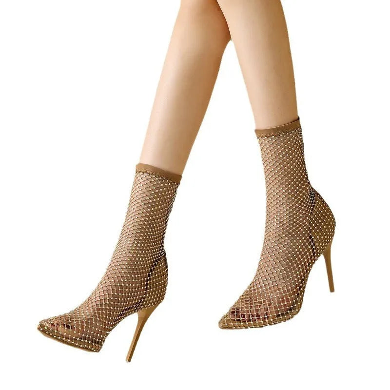 Gold women's high heel sandals with pointed stiletto heel and mesh upper on a rubber sole.