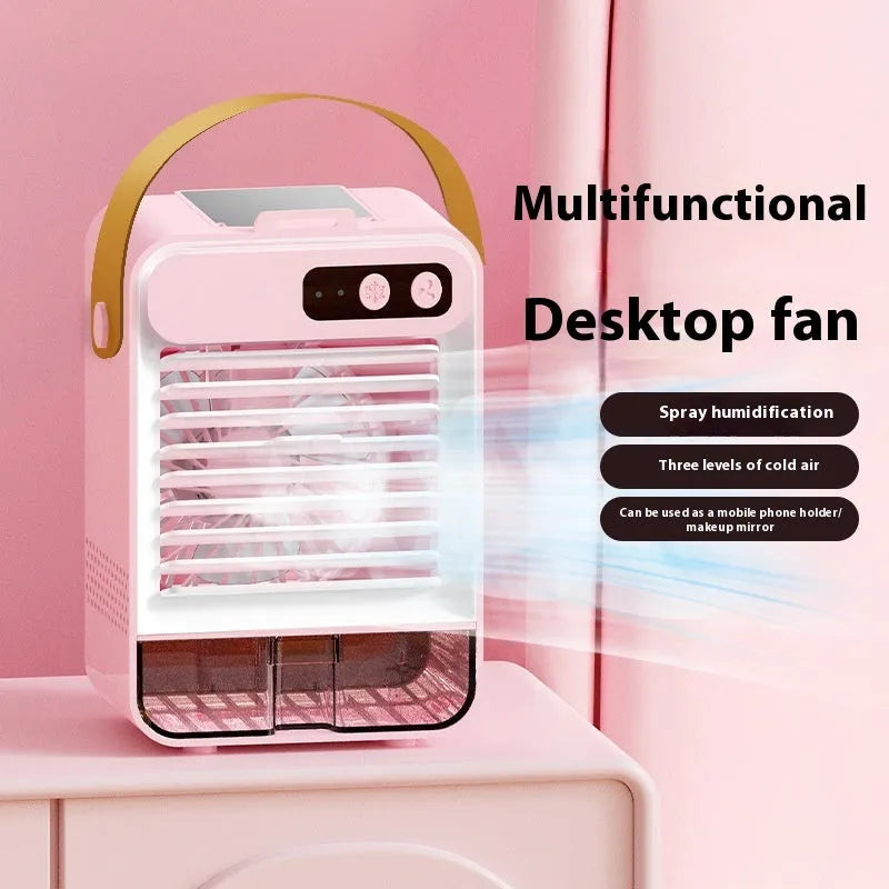 Compact dark green desktop fan with plastic blades and USB cable on a wooden desk