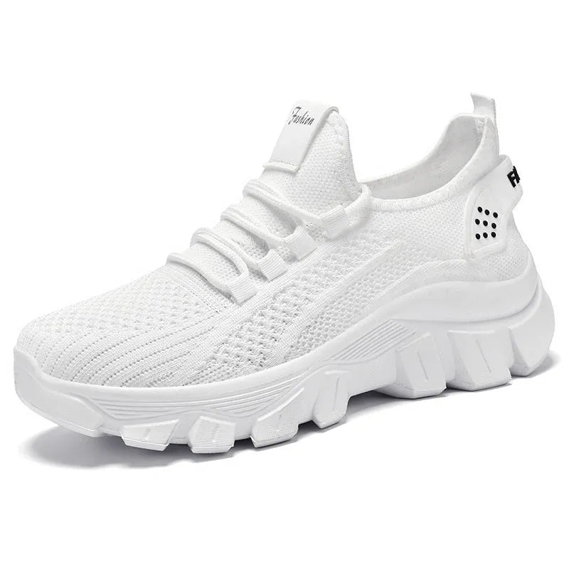 Women's white Flyknit sneaker with thick PVC sole and lace-up closure on a neutral background.