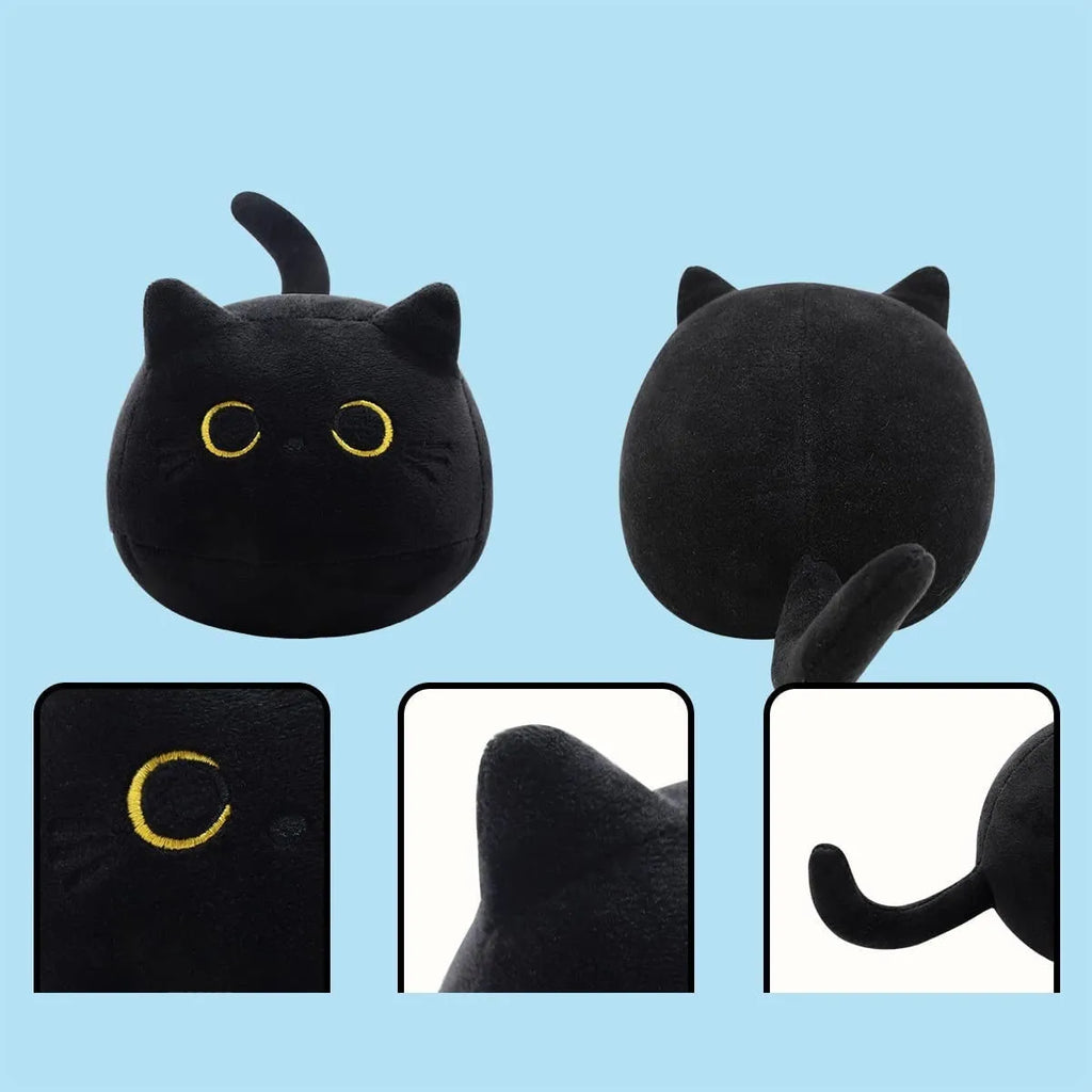 Fluffy black cat plush toy used as a soft pillow cushion on a sofa.