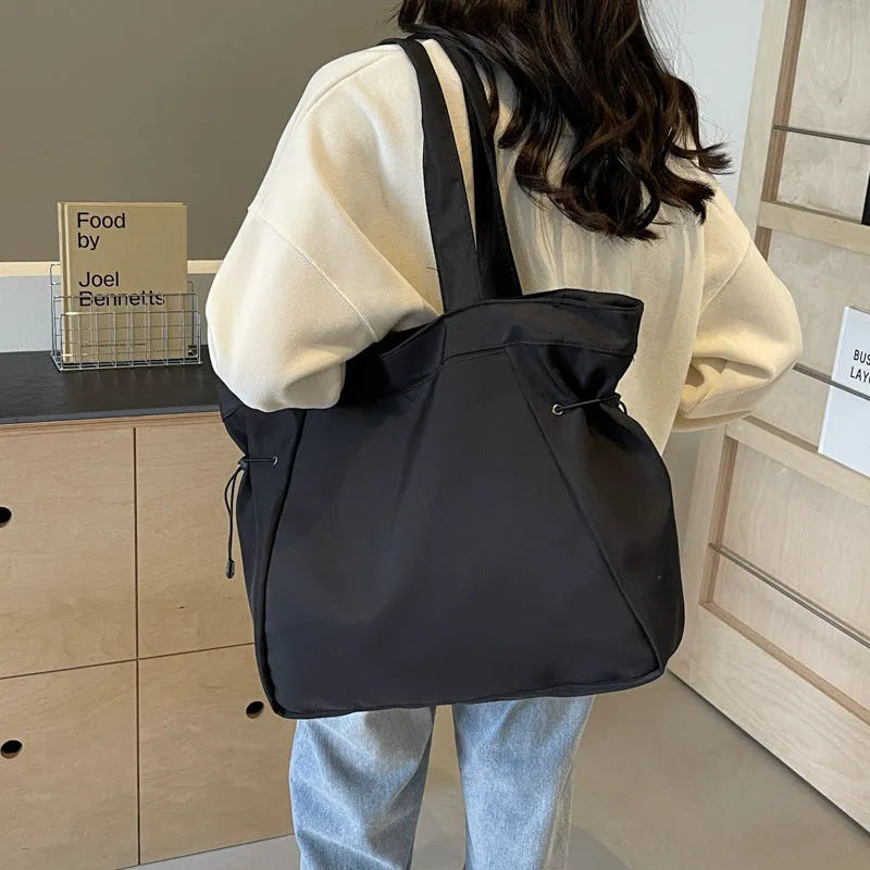 Soft Oxford cloth foldable tote bag in street style, shown in available colours.