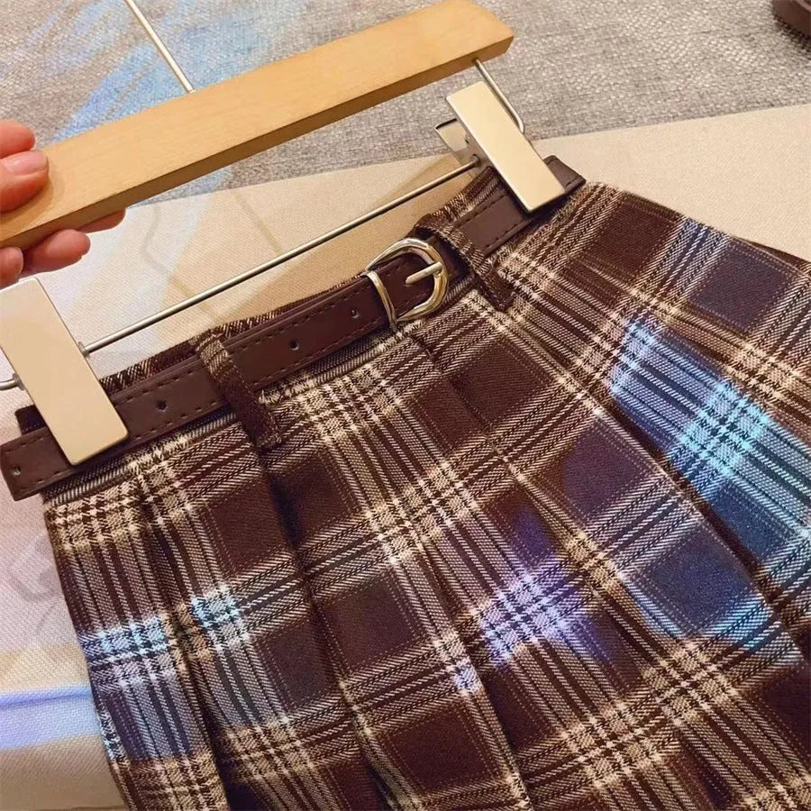 Girls plaid pleated A-line skirt in cotton-blend fabric, shown on a hanger.