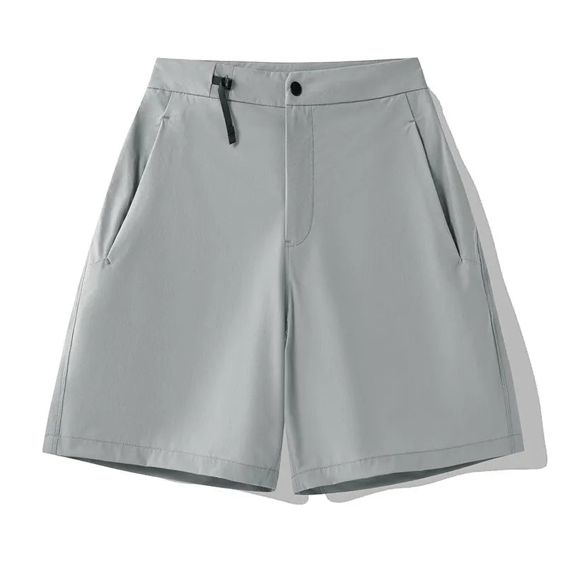 Man wearing khaki quick-drying sports shorts with an elastic waistband for running or climbing.