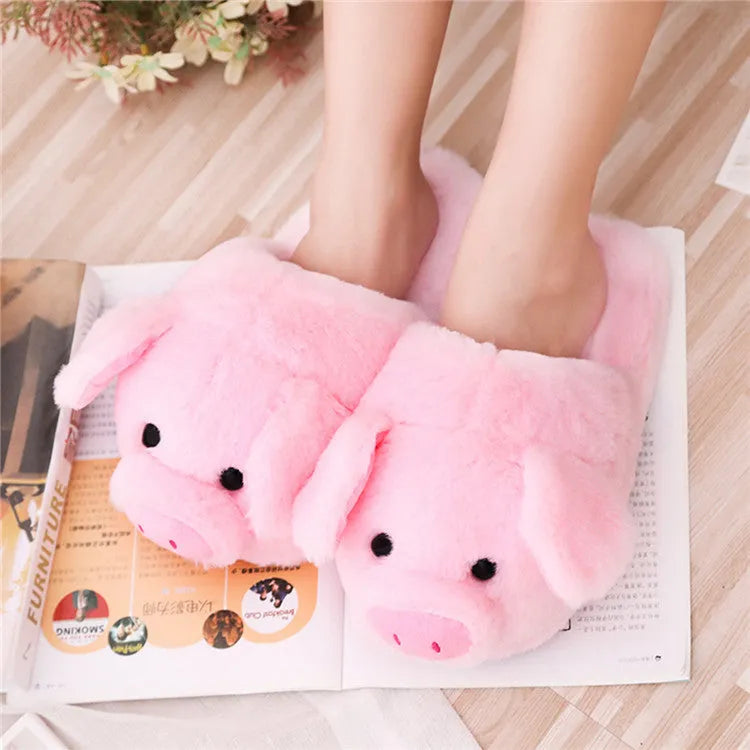 Pink pig-shaped floor slippers with short plush fabric and a soft padded interior.