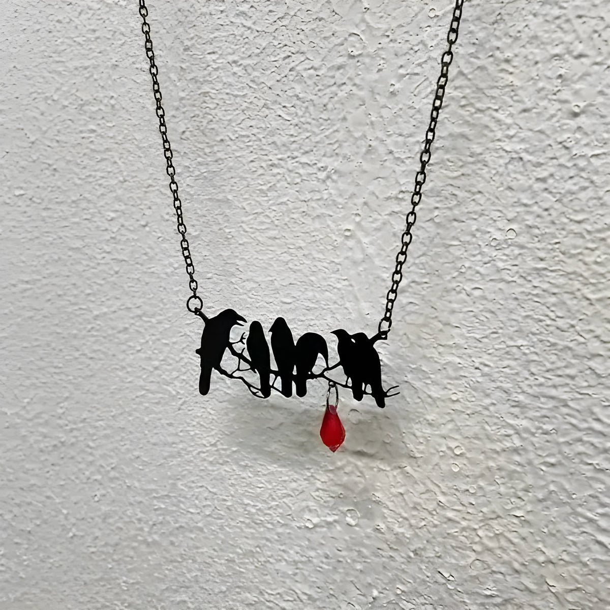 Black electroplated alloy crow necklace with cross chain design and zodiac elements