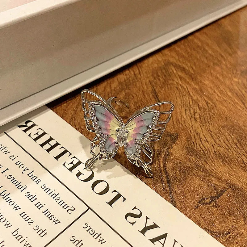 Copper butterfly women's ring with drip oil finish in an open-loop design.