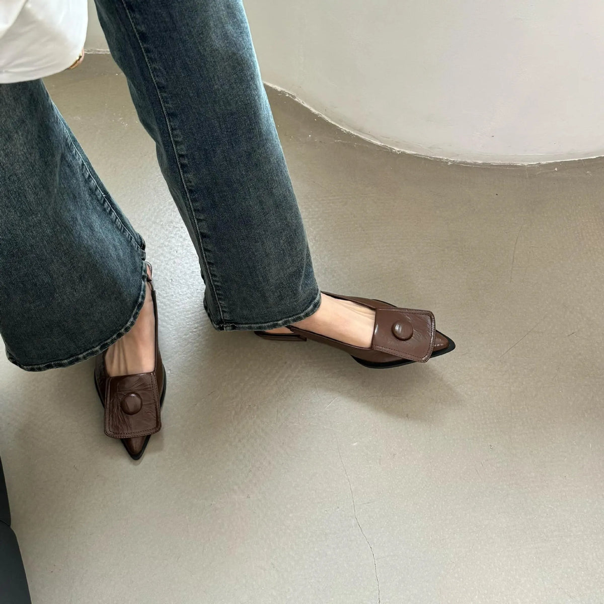 Women's low-heel pointed toe sandals with a back strap in apricot colour on a white background.