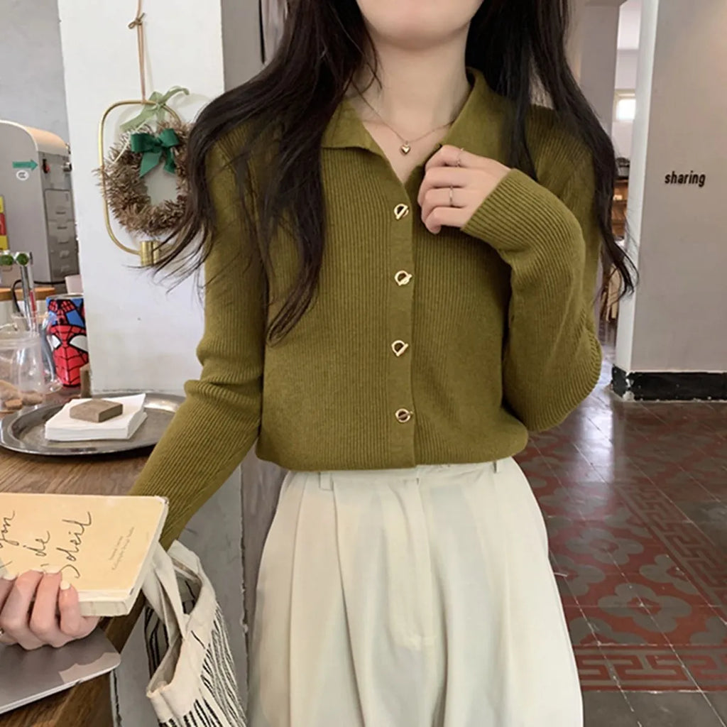 Loose fit beige viscose knitted cardigan top with long sleeves on a hanger