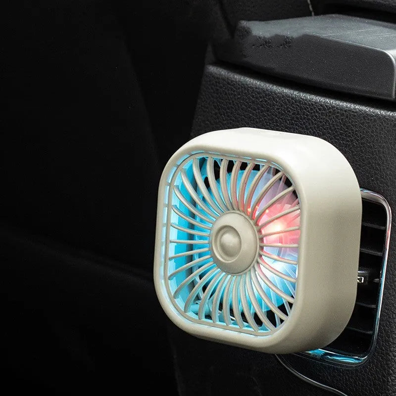 Compact black USB car fan with three speed buttons on dashboard