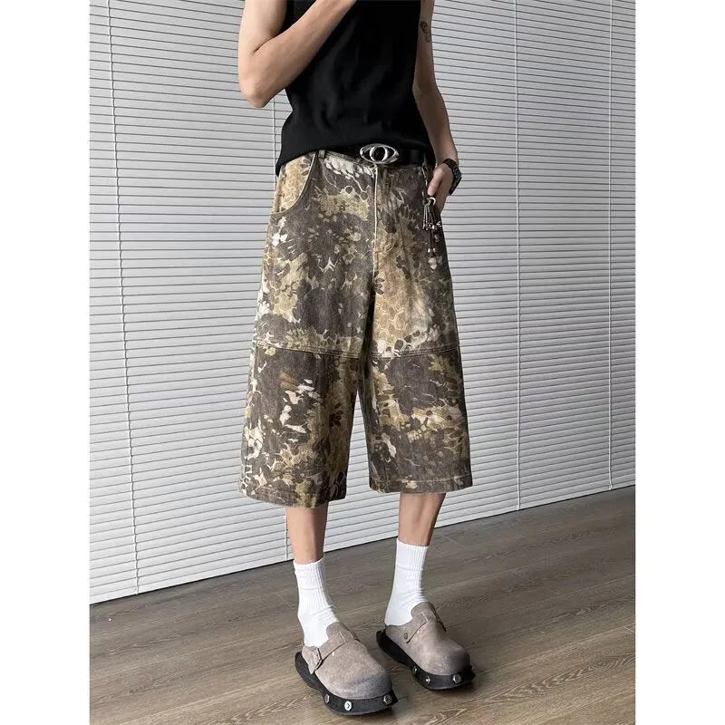 Women's yellow snake pattern camouflage print cropped denim jeans laid flat.