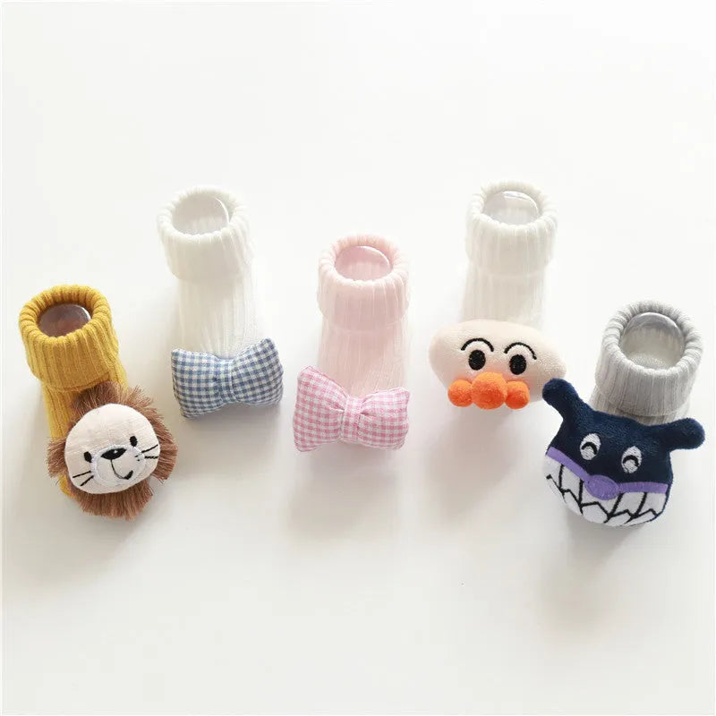 Cotton baby floor socks in a selection of colours and patterns like panda, lion, and bows, shown in sizes for infants.