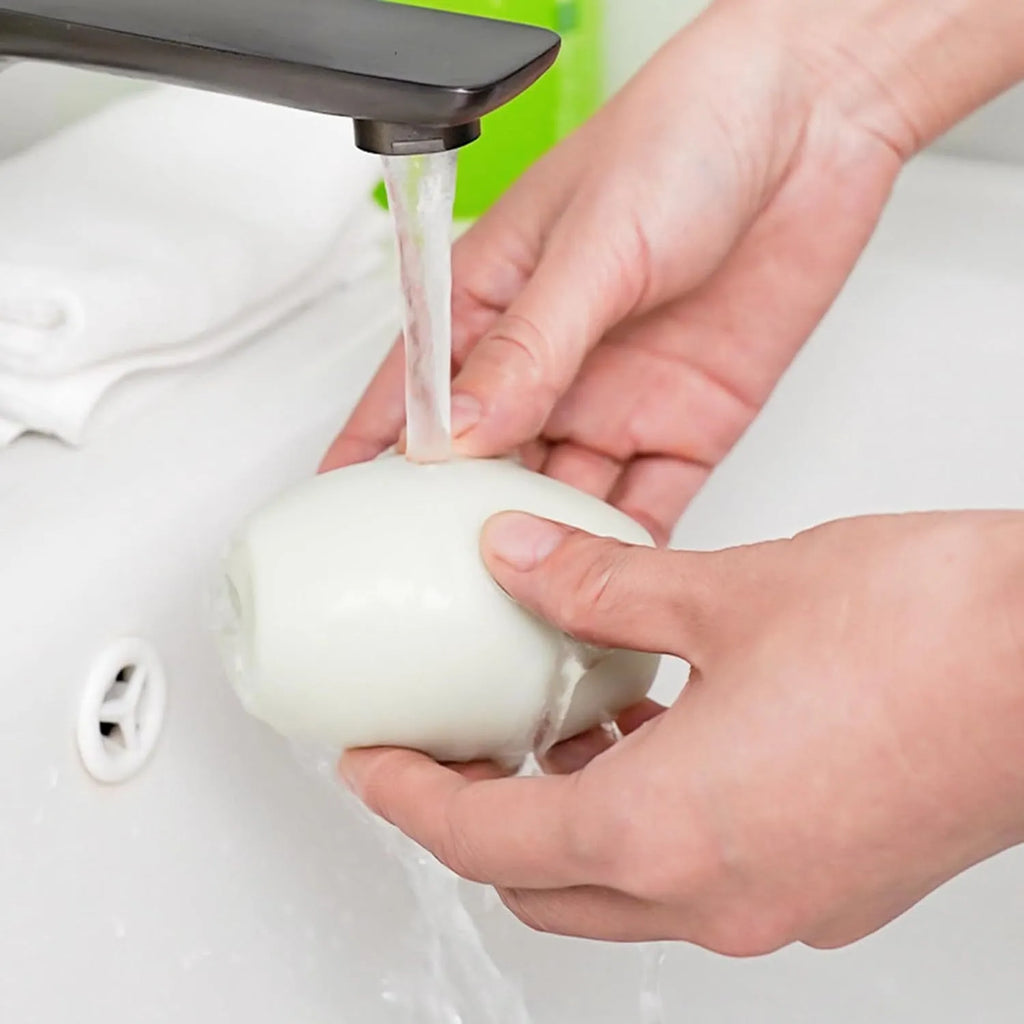Green reusable gel lint roller ball for pet hair removal on fabric