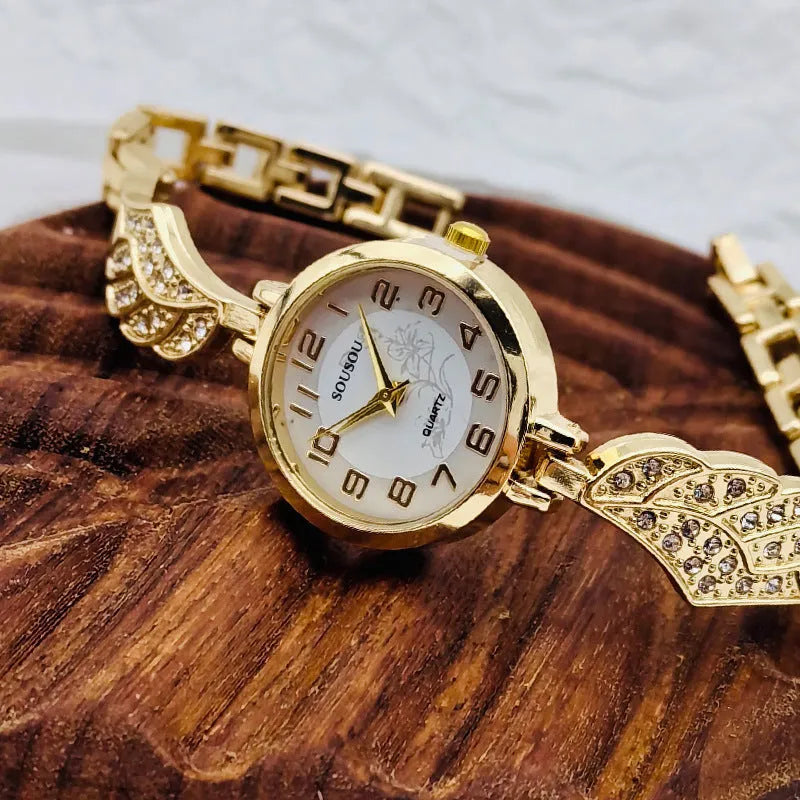 Women's stainless steel watch with round dial showing gold surface, 9mm thickness, and vachette clasp buckle