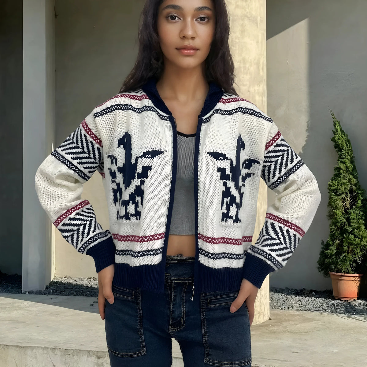White women's cardigan sweater with a front zipper, lapel collar, and a vertical jacquard contrast stripe.