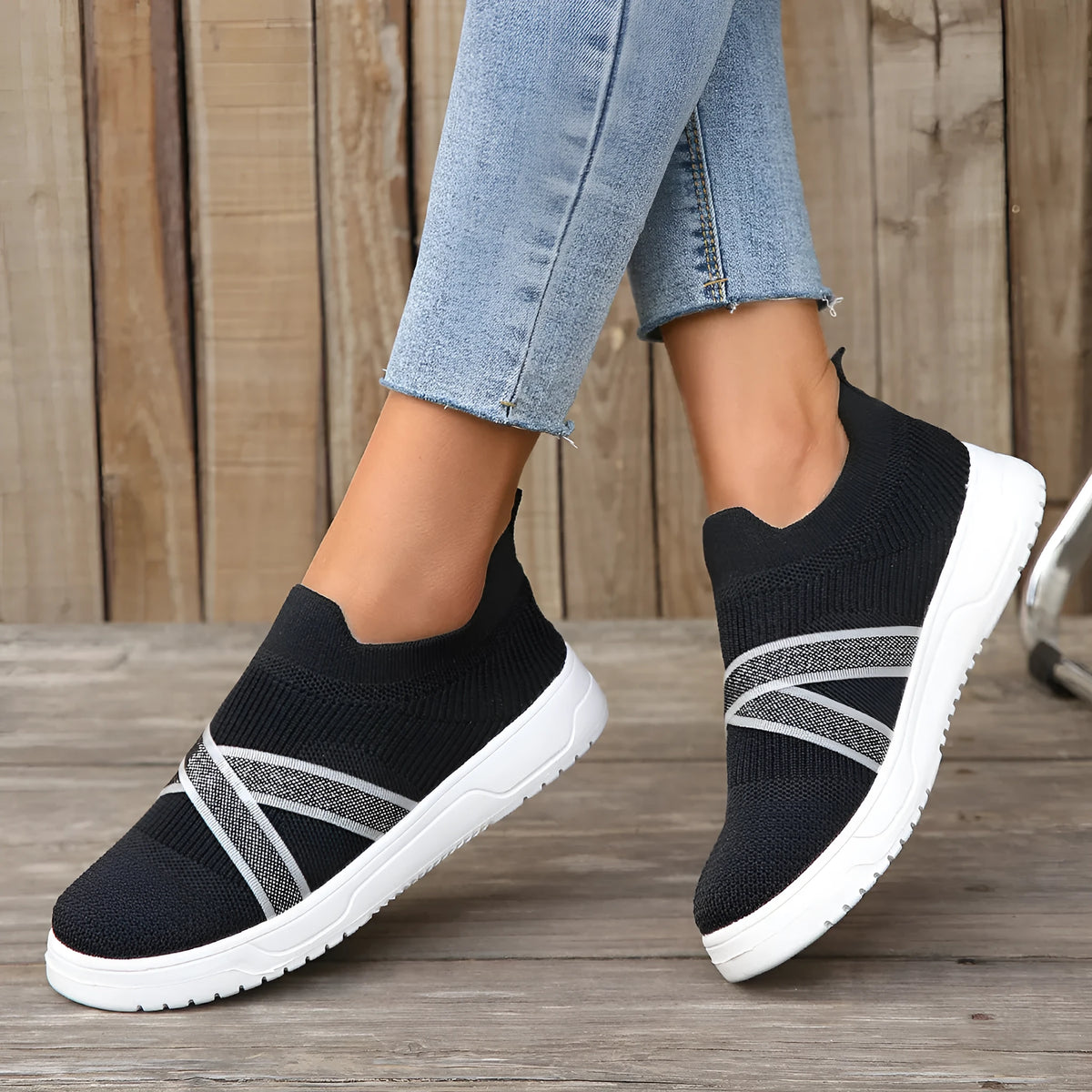 Black women's flyknit mesh casual shoes with flat rubber sole and round toe.
