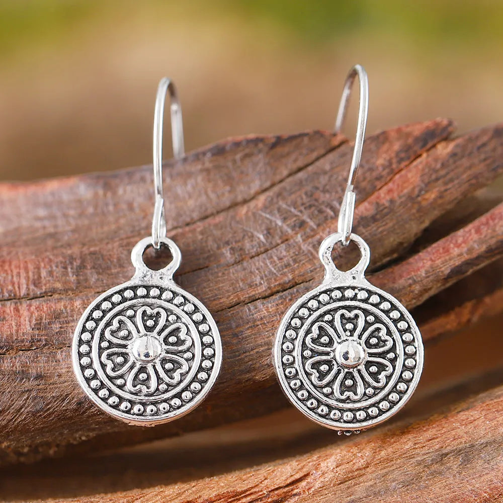 Round geometric earrings with distressed ethnic print in electroplated zinc alloy