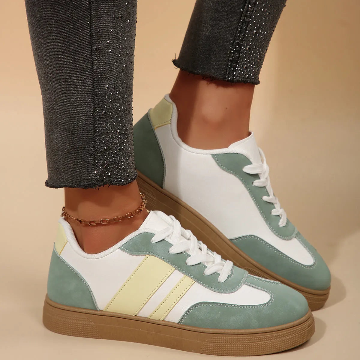 Green women's low-top casual pumps with cross-strap design and flat rubber sole.