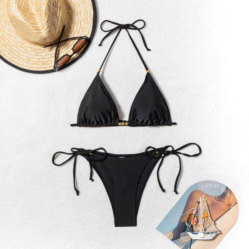 Black women's bikini swimsuit with metal bead decoration and split design