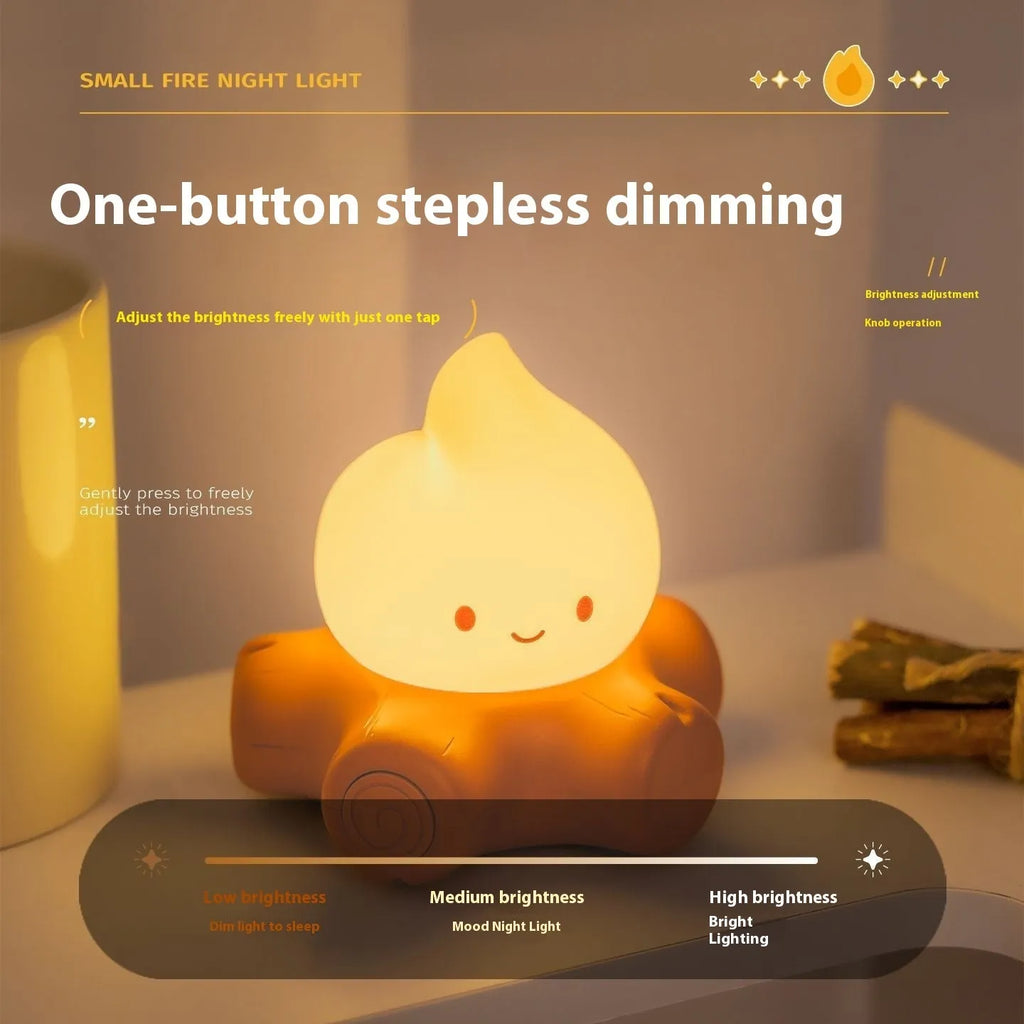 Small cartoon silicone fire pile night lamp with yellow glow on a surface