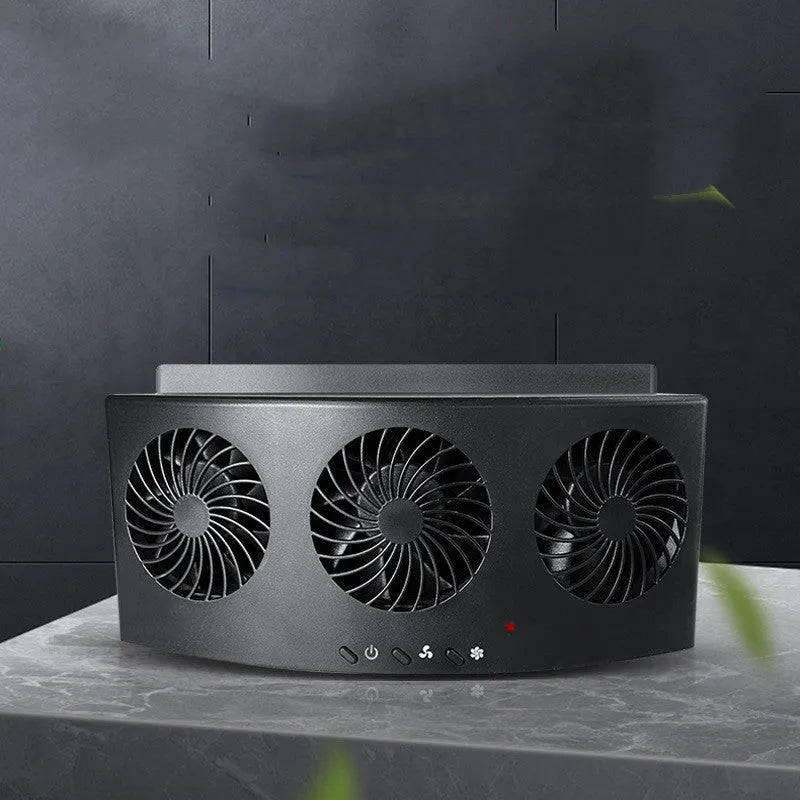 Black and white car ventilation fan with USB power cord on a car dashboard.