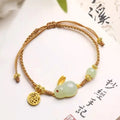 Yellow string bracelet with a geometric Hetian jade rabbit charm for women.
