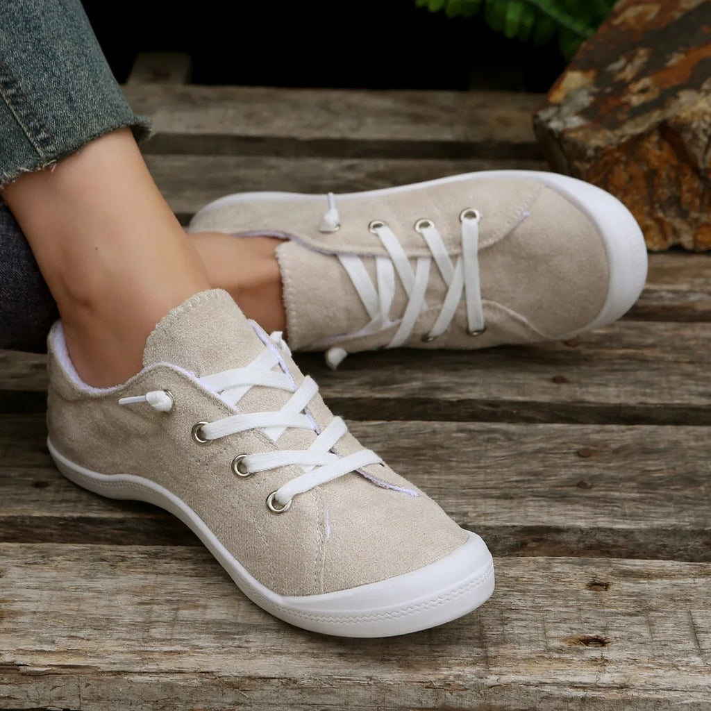 Women's creamy-white casual sneakers with low top fabric upper and rubber sole