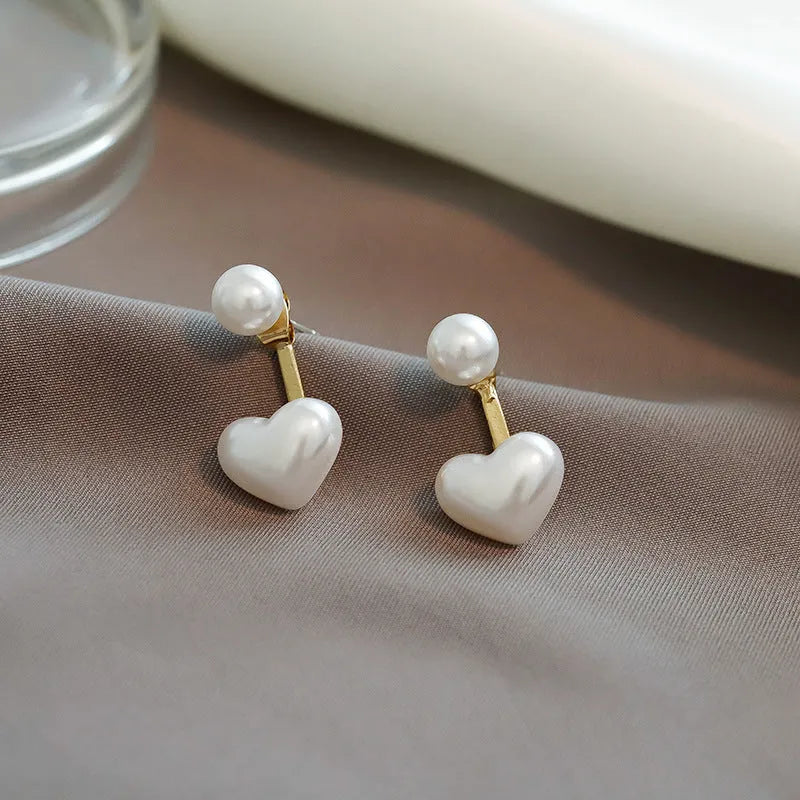 Heart-shaped pearl stud earrings with artificial gemstone accents on electroplated alloy settings