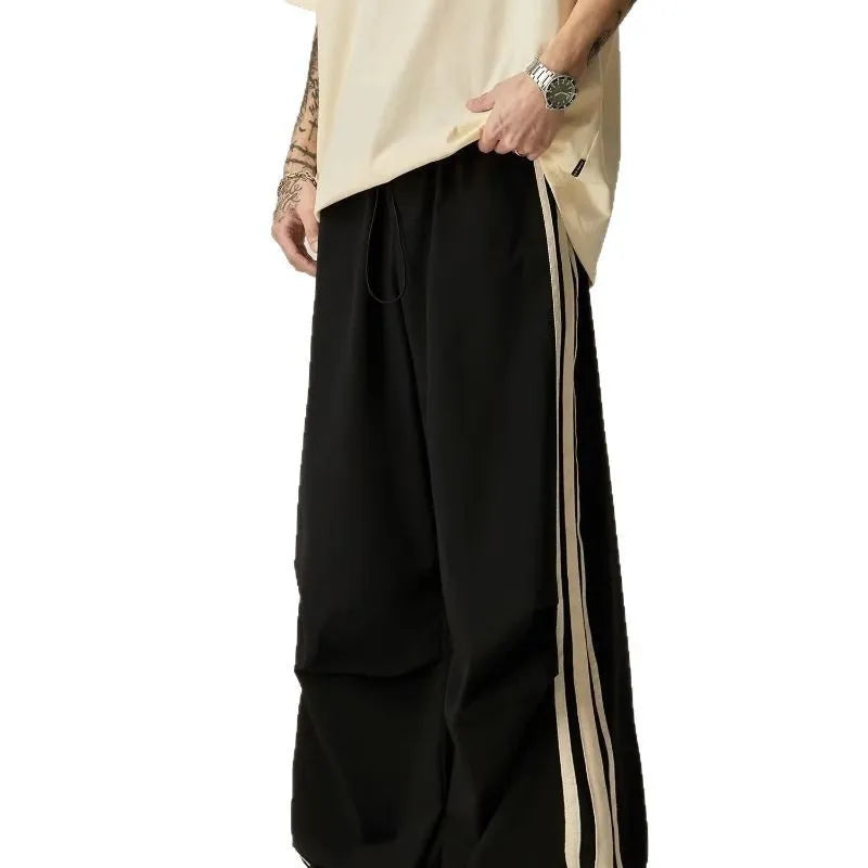 Black wide leg climbing trousers with high waist and straight leg design on hanger