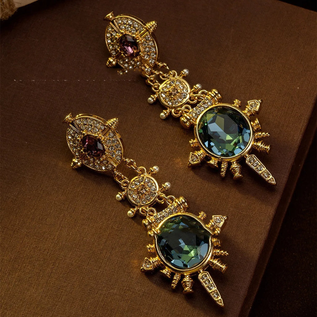 Geometric gold coloured retro stud earrings with round design elements on alloy stud backs