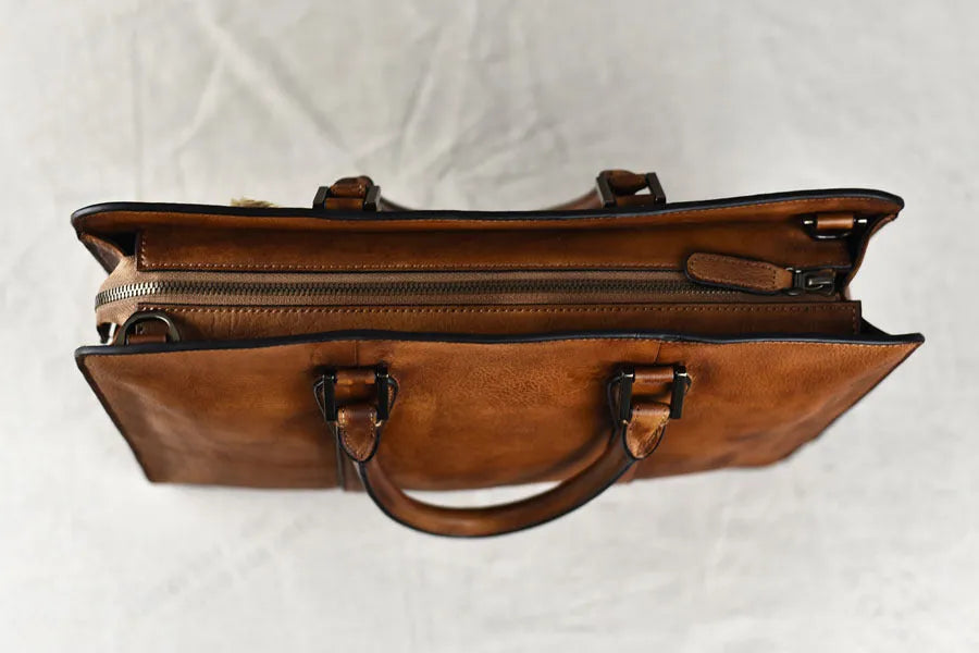 Men's brown leather horizontal square handbag with zipper opening showing 14 inch size