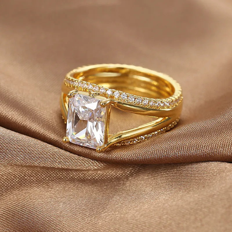 Gold square zircon geometric ring on finger showing electroplated copper construction