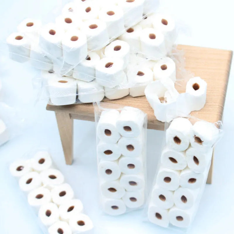 Miniature simulated toilet paper roll model made from paper, shown at 30mm by 15mm by 80mm scale.