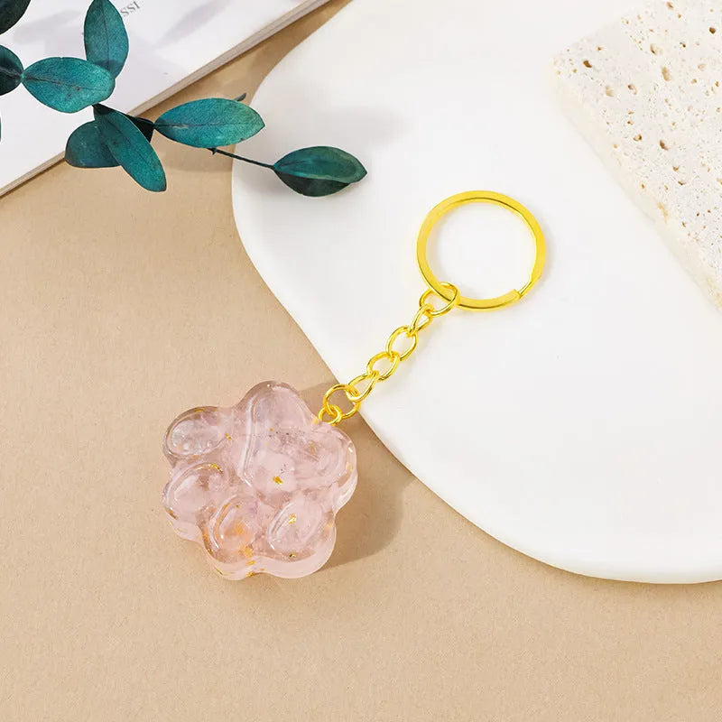 Small handcrafted crystal cat's paw shaped keychain pendant on a keyring.