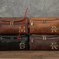 Men's black PU leather travel toiletry bag for grooming storage.