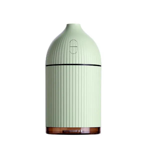 White ultrasonic aromatherapy diffuser humidifier with USB cable and LED light on wooden table
