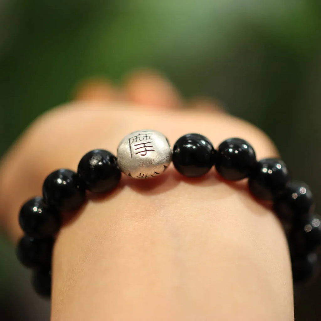 Black agate bracelet with sterling silver clasp showing Chinese style design