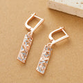 A pair of rectangular two-tone hollow stud earrings with an electroplated finish on a white background.