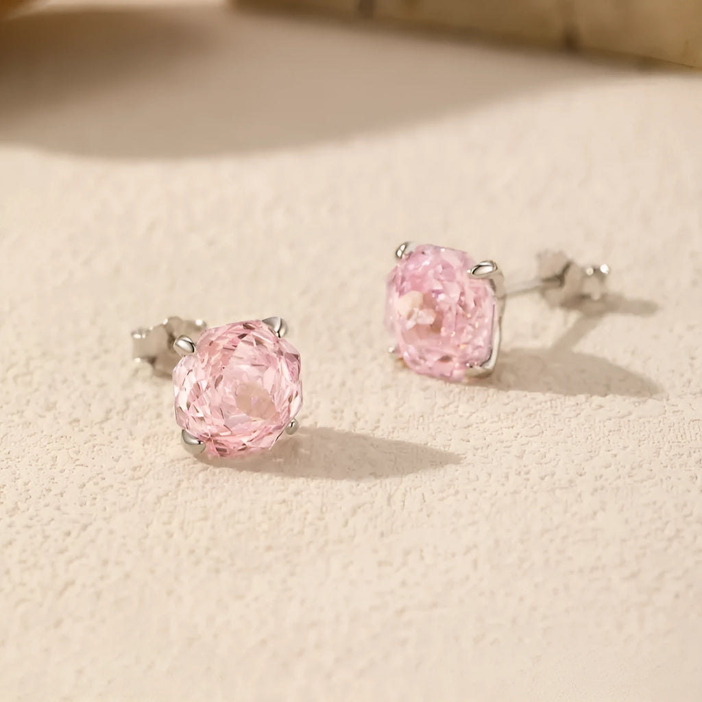 Close-up of a pair of pink rose-shaped stud earrings made of S925 sterling silver, shown front and back.
