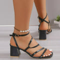 Plus size beige open toe slippers with square toe and ankle buckle on a rubber sole.