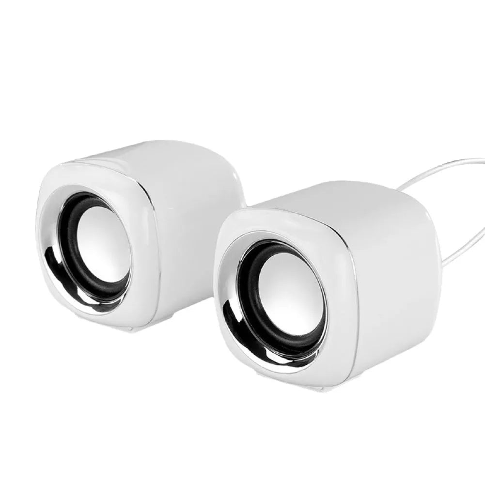 A pair of small black wired desktop computer speakers with a volume scroll wheel.
